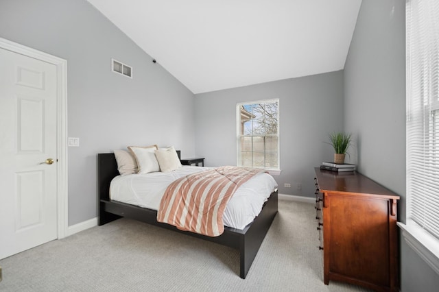 bedroom with carpet floors, baseboards, visible vents, and vaulted ceiling