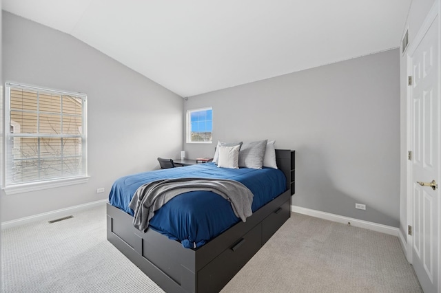 carpeted bedroom featuring visible vents, vaulted ceiling, and baseboards