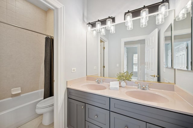 bathroom featuring shower / bath combination with curtain, a sink, toilet, and double vanity