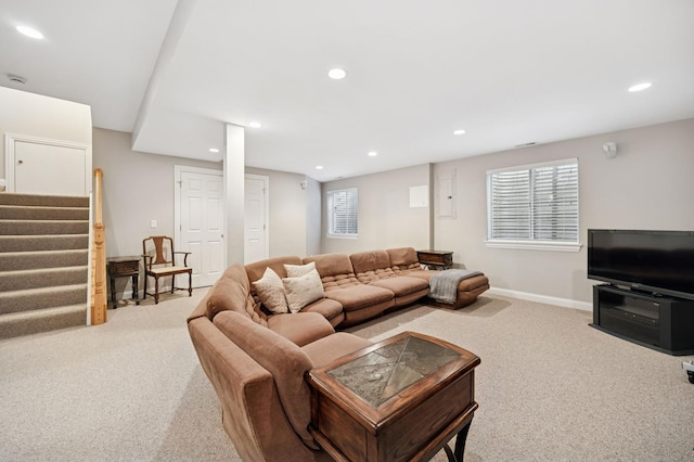 carpeted living area with stairs, baseboards, and recessed lighting