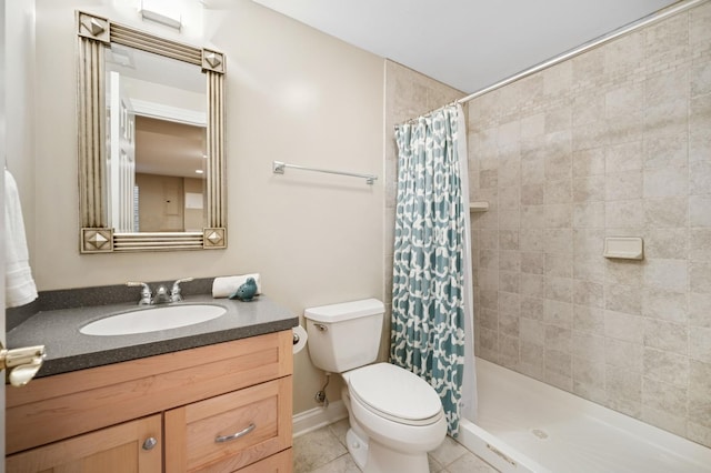 full bathroom featuring tiled shower, vanity, toilet, and tile patterned floors