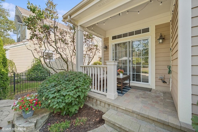 exterior space with a porch and fence