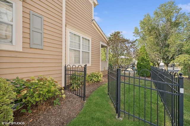 view of gate featuring a yard and fence