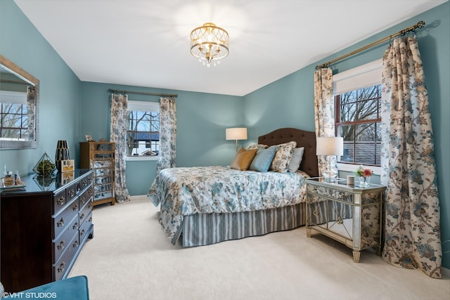 bedroom with a notable chandelier and carpet floors