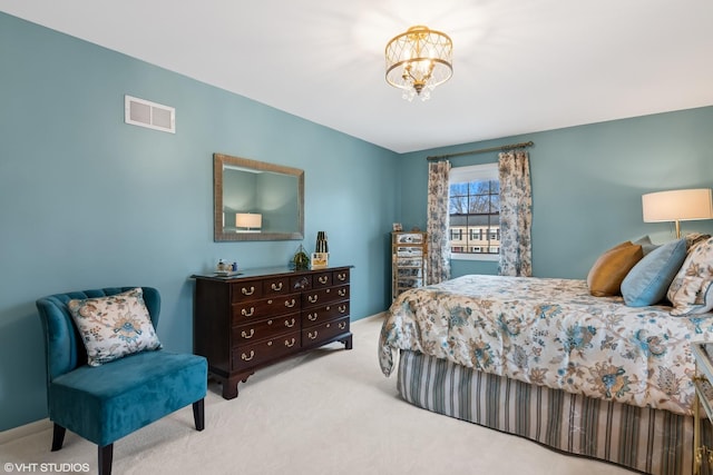 bedroom with a notable chandelier, carpet flooring, and visible vents