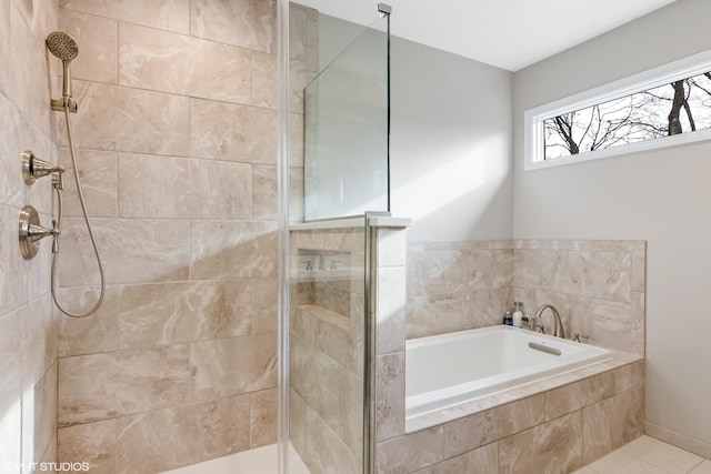 bathroom with a bath, tile patterned flooring, and a tile shower