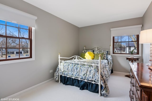 bedroom featuring baseboards and carpet