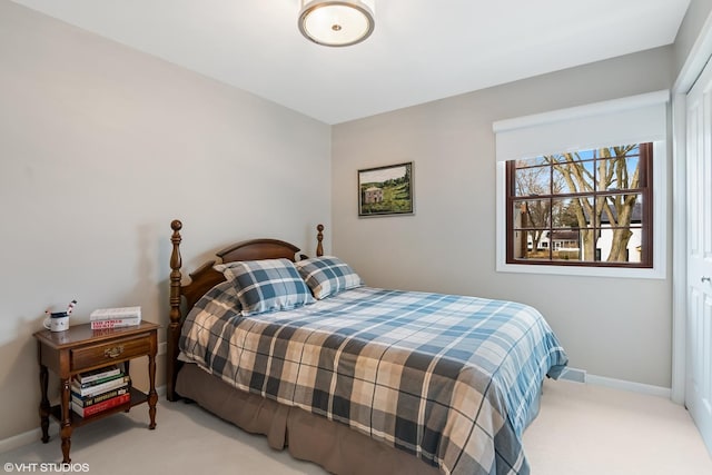 bedroom with baseboards and carpet flooring