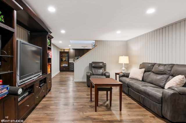 living room featuring recessed lighting, stairway, and wood finished floors