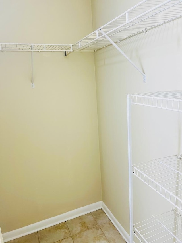 spacious closet featuring tile patterned flooring