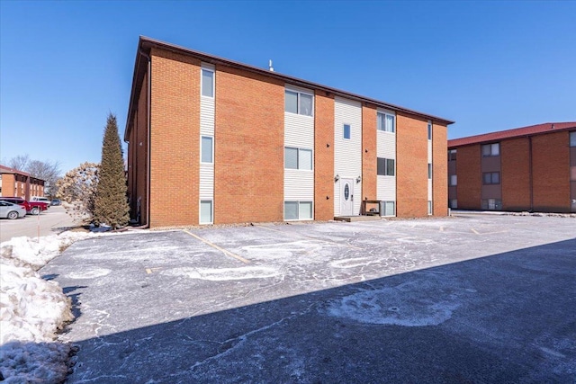 view of building exterior featuring uncovered parking