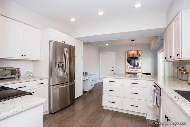 kitchen featuring dark wood-style flooring, white cabinets, appliances with stainless steel finishes, backsplash, and decorative light fixtures