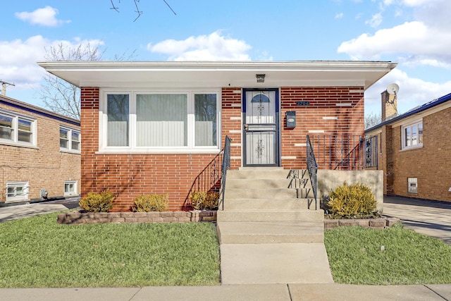 bungalow-style house featuring a front lawn and brick siding