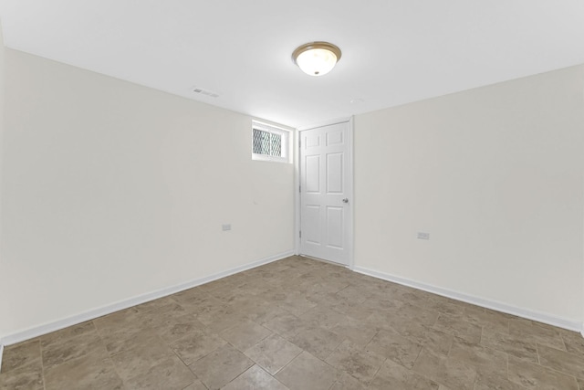 empty room featuring visible vents and baseboards