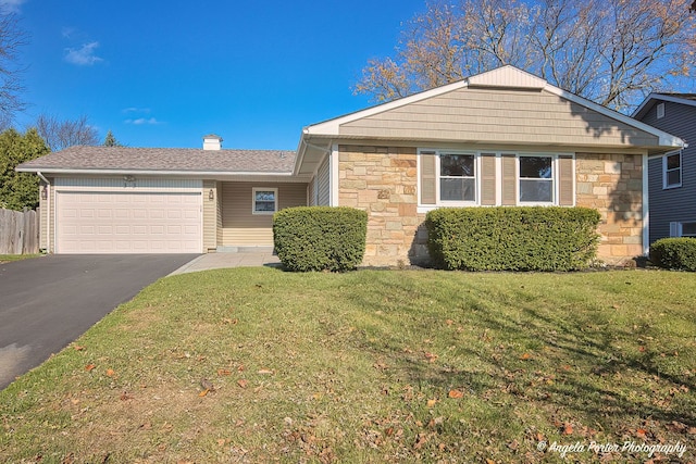 view of front facade featuring an attached garage, stone siding, driveway, a chimney, and a front yard