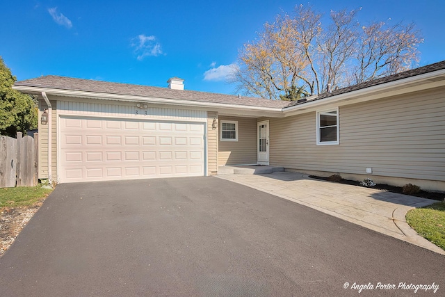 ranch-style home with driveway and a garage