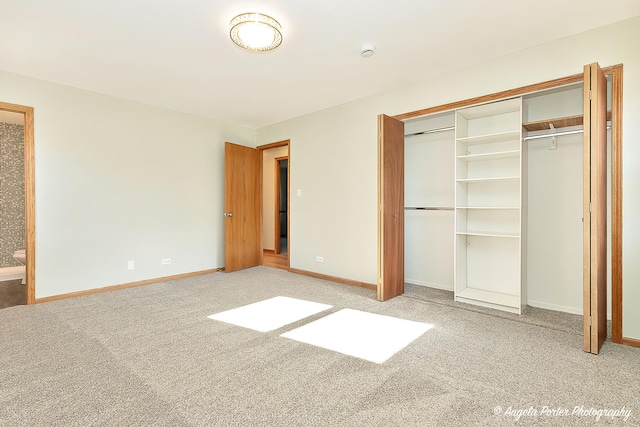 unfurnished bedroom featuring carpet floors, a closet, and baseboards