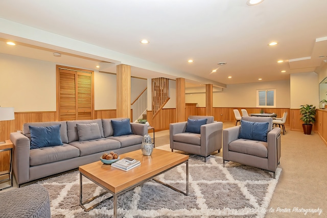 living area featuring wooden walls, light colored carpet, a wainscoted wall, stairway, and recessed lighting