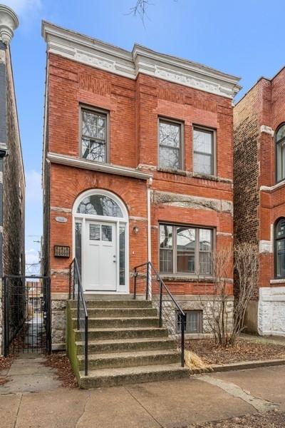 view of front of house featuring entry steps and brick siding