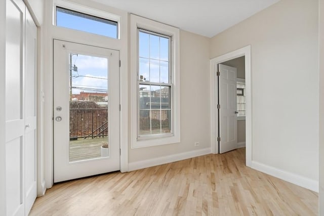 doorway to outside featuring light wood-style floors and baseboards