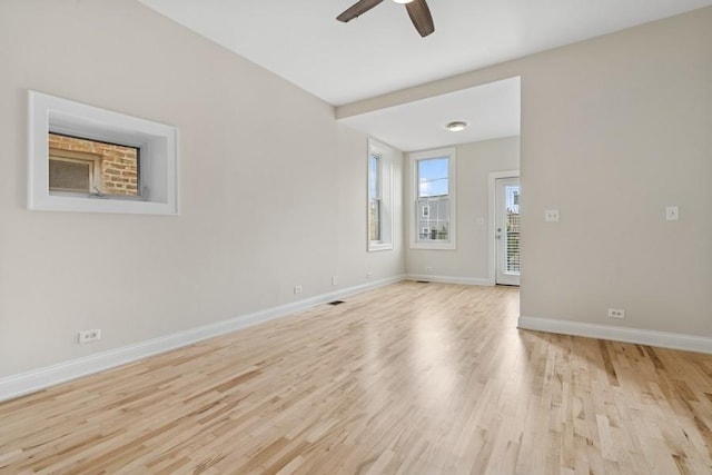 unfurnished room with light wood-style flooring, baseboards, and a ceiling fan