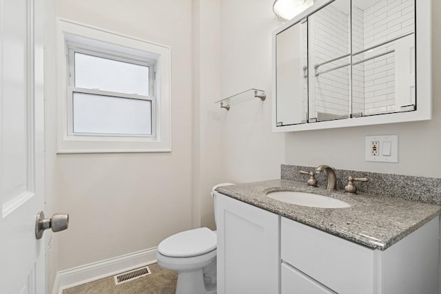 half bathroom featuring toilet, baseboards, visible vents, and vanity