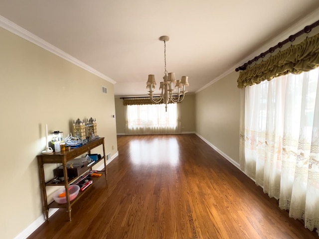 dining area featuring baseboards, crown molding, a chandelier, and dark wood-style flooring