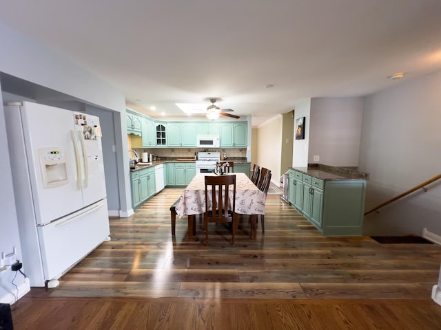 dining area with dark wood finished floors, baseboards, and ceiling fan