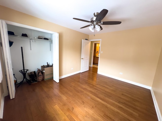 unfurnished bedroom with ceiling fan, a closet, wood finished floors, and baseboards