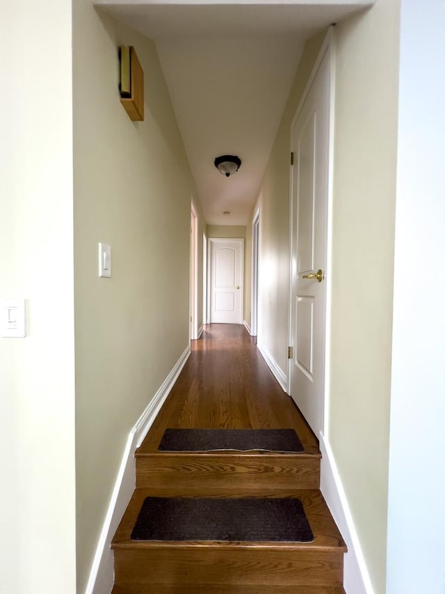 hall featuring dark wood-style floors and baseboards