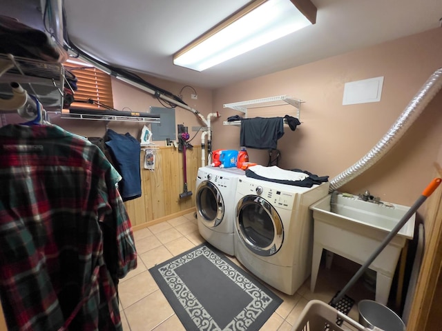 clothes washing area featuring light tile patterned floors, laundry area, and washer and clothes dryer