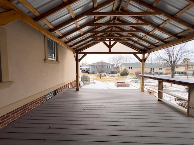 snow covered deck with a residential view