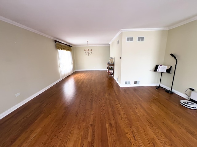 unfurnished living room featuring dark wood-type flooring, visible vents, baseboards, ornamental molding, and an inviting chandelier