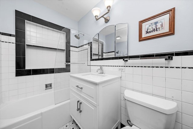 bathroom featuring bathing tub / shower combination, vanity, toilet, and tile walls