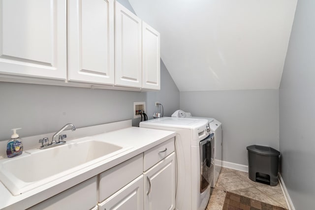 laundry room with washer and dryer, cabinet space, a sink, and baseboards