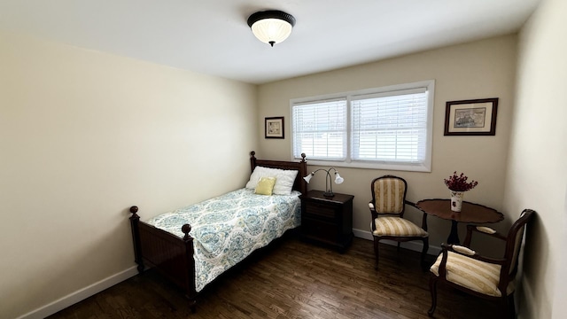 bedroom featuring dark wood-style floors and baseboards