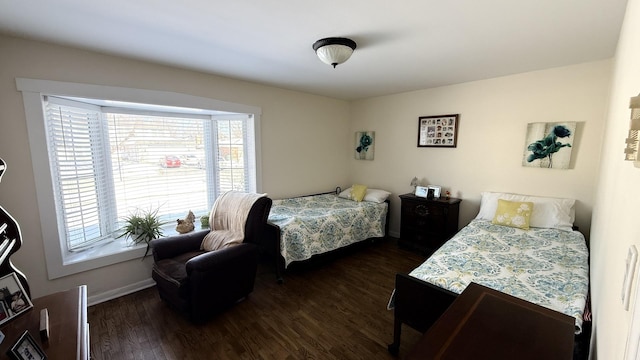 bedroom with baseboards and dark wood finished floors