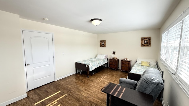 bedroom featuring baseboards and wood finished floors