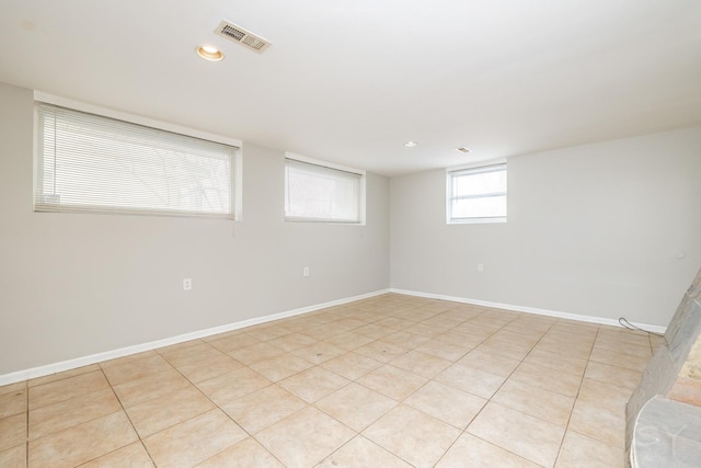 spare room featuring recessed lighting, visible vents, and baseboards