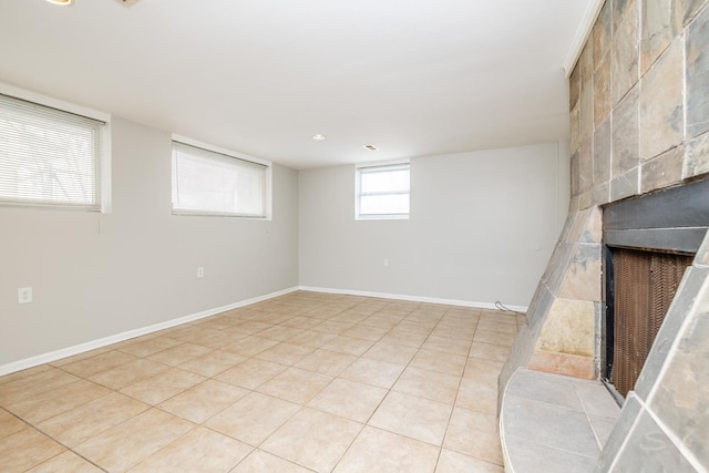 basement featuring baseboards and light tile patterned floors