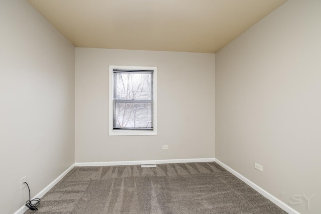 carpeted empty room with baseboards