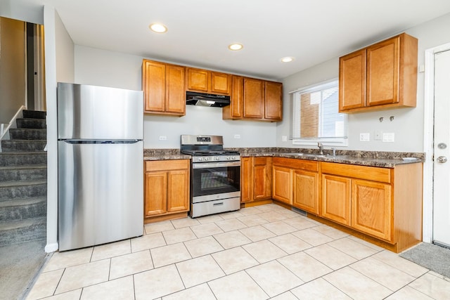 kitchen featuring brown cabinets, recessed lighting, appliances with stainless steel finishes, a sink, and under cabinet range hood