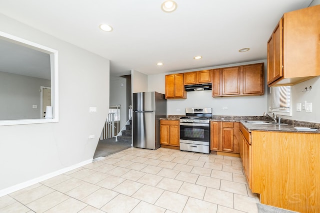 kitchen featuring stainless steel appliances, recessed lighting, brown cabinetry, a sink, and under cabinet range hood