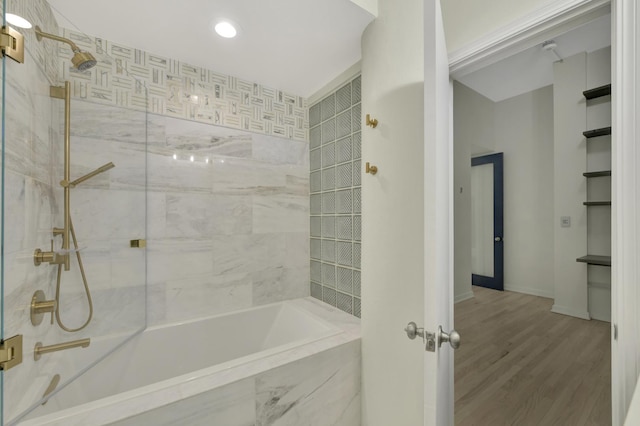 bathroom featuring a combined bath / shower with marble appearance and wood finished floors