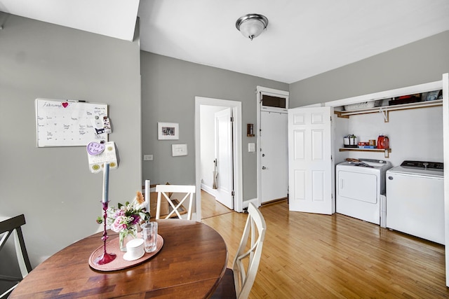 dining room featuring light wood finished floors, separate washer and dryer, and baseboards