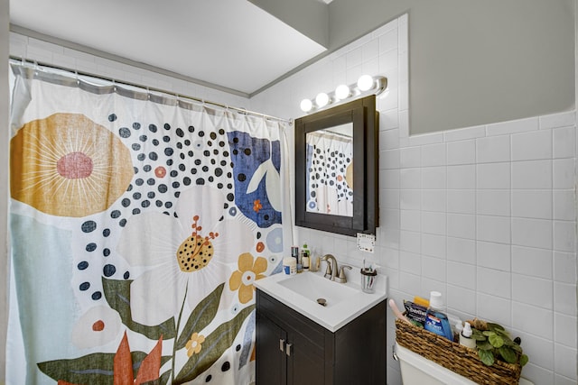 full bathroom featuring curtained shower, toilet, tile walls, and vanity