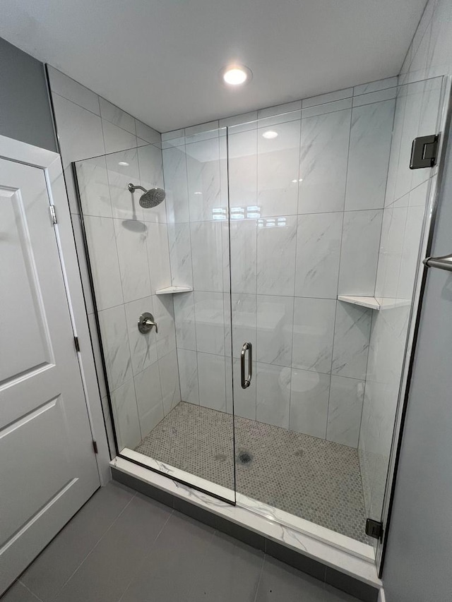 full bathroom with a stall shower and tile patterned floors