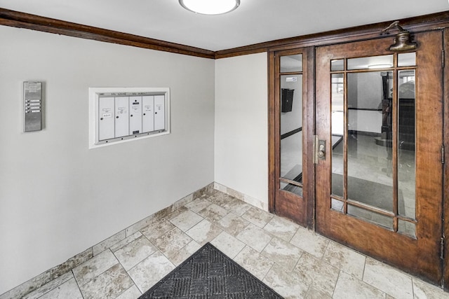 empty room with baseboards, crown molding, and mail area