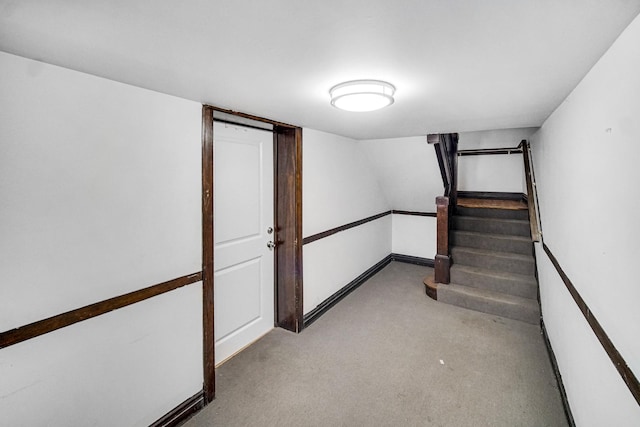 stairway with carpet floors and baseboards