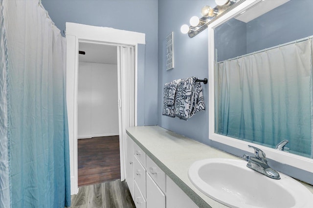 bathroom with vanity and wood finished floors